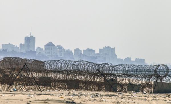 A picture taken from the beach in the southern Israeli kibbutz of Zikim shows the skyline of Gaza City