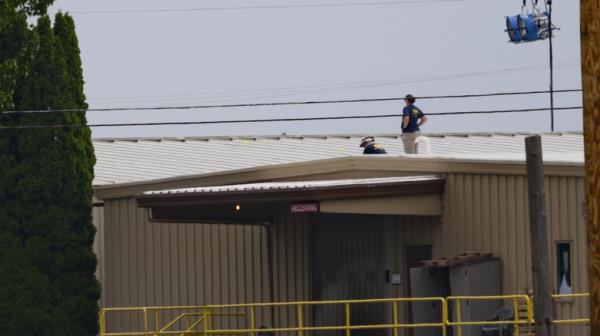 FBI agents standing on warehouse roof