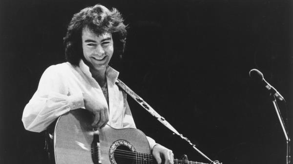 Neil Diamond on stage with guitar