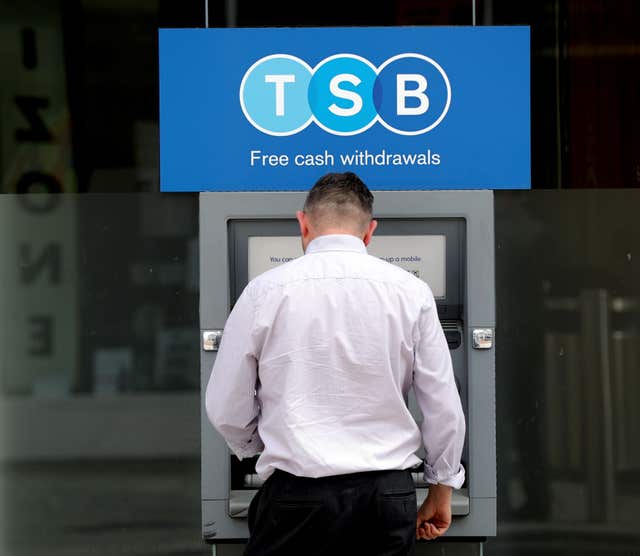 A man uses a TSB cash machine 