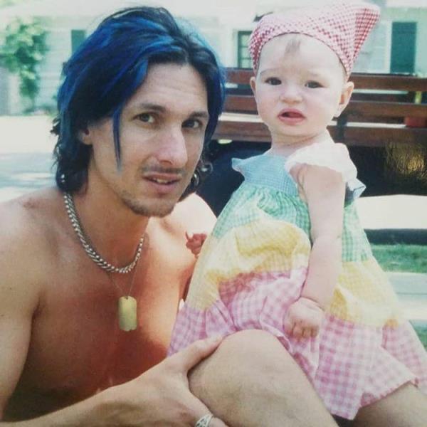 Lucy as a child in the pool with her biological father, Mark Knight.