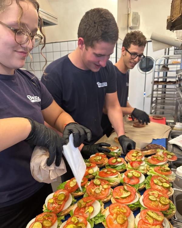 Young people preparing burgers